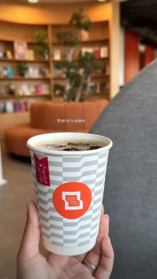 Notery café interior with Notery-branded coffee cup
